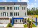 Attractive three-story townhome featuring neutral siding, a garage, and manicured landscaping with palm trees at 8470 Duke Pl. # 29, Myrtle Beach, SC 29572