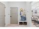 Hallway entryway with bench, hat, bags, and storage baskets with view into display room at 8470 Duke Pl. # 29, Myrtle Beach, SC 29572