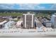 Panoramic aerial view showing a beachfront condo surrounded by beaches, trees, and nearby buildings at 912 N Waccamaw Dr. # 202, Garden City Beach, SC 29576