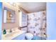 Charming bathroom with a white vanity, seashell shower curtain, and coordinated nautical decor at 912 N Waccamaw Dr. # 202, Garden City Beach, SC 29576