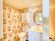 Compact bathroom featuring a vanity, toilet, mirror, and a shower-tub combination with themed shower curtain at 912 N Waccamaw Dr. # 202, Garden City Beach, SC 29576