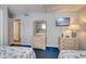 View of bedroom featuring twin beds, side tables, and dressers with mirrors in a light color at 912 N Waccamaw Dr. # 202, Garden City Beach, SC 29576