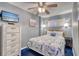 Serene bedroom with calming gray walls, comfortable bed, television, and ceiling fan for added comfort at 912 N Waccamaw Dr. # 202, Garden City Beach, SC 29576