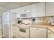 Efficient kitchen with essential appliances, white cabinetry, and ample counter space for meal preparation at 912 N Waccamaw Dr. # 202, Garden City Beach, SC 29576