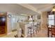 Bright kitchen featuring a breakfast bar, white cabinetry, tile flooring, and a dining area with seating at 912 N Waccamaw Dr. # 202, Garden City Beach, SC 29576
