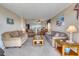 Cozy living room featuring comfortable seating, a ceiling fan, and an open floor plan with views into the kitchen at 912 N Waccamaw Dr. # 202, Garden City Beach, SC 29576