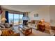 Comfortable living area with access to a balcony overlooking the beach at 912 N Waccamaw Dr. # 202, Garden City Beach, SC 29576