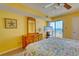 Comfortable bedroom offering balcony access, wooden furnishings, and beautiful ocean views from a nearby window at 912 N Waccamaw Dr. # 202, Garden City Beach, SC 29576