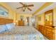 Bright bedroom with a wooden dresser, ceiling fan, and easy access to the bathroom and kitchen areas at 912 N Waccamaw Dr. # 202, Garden City Beach, SC 29576