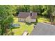 Aerial view of a backyard featuring lush grass and a concrete patio surrounding the charming single-Gathering home at 938 Fox Hollow Rd., Conway, SC 29526