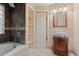 Bathroom featuring dark ceramic tiles in the walk-in shower, and a wood vanity at 938 Fox Hollow Rd., Conway, SC 29526