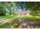 Exterior of home with large lawn, lots of mature trees and side porch at 938 Fox Hollow Rd., Conway, SC 29526