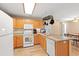 Efficient kitchen layout with white appliances, light wood cabinets, and access to dining area at 938 Fox Hollow Rd., Conway, SC 29526