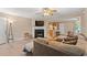 Comfortable living room features a fireplace, ceiling fan and an open floorplan to dining room and kitchen at 938 Fox Hollow Rd., Conway, SC 29526