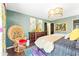 Comfortable bedroom featuring wood floors, a decorative chair, vibrant wall art, and unique gold lighting at 9755 Leyland Dr. # 2, Myrtle Beach, SC 29572