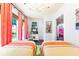 Well-lit bedroom featuring twin beds, vibrant curtains, and a sun-filled window, creating a cozy space at 9755 Leyland Dr. # 2, Myrtle Beach, SC 29572