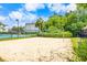A sand volleyball court next to the tennis courts with a lush green surround and cloud filled sky at 9755 Leyland Dr. # 2, Myrtle Beach, SC 29572