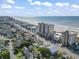 Expansive aerial view of a condo complex, beach and nearby homes at 1003 S Ocean Blvd. # 802, North Myrtle Beach, SC 29582