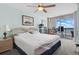 Bright bedroom with ceiling fan and sliding glass doors leading to a private balcony with ocean views at 1003 S Ocean Blvd. # 802, North Myrtle Beach, SC 29582