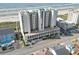 Aerial view of beach condo, showing parking garage, and view of ocean at 1003 S Ocean Blvd. # 802, North Myrtle Beach, SC 29582