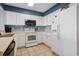 Bright kitchen with white cabinets, stainless steel microwave, and tile floors at 1003 S Ocean Blvd. # 802, North Myrtle Beach, SC 29582