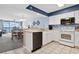 Open-concept kitchen featuring white appliances and cabinetry with tile flooring at 1003 S Ocean Blvd. # 802, North Myrtle Beach, SC 29582