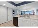 A kitchen area with white cabinets, a dishwasher, and views into the living room at 1003 S Ocean Blvd. # 802, North Myrtle Beach, SC 29582