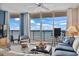 Inviting living room with cozy seating and sliding glass doors leading to a private balcony with ocean views at 1003 S Ocean Blvd. # 802, North Myrtle Beach, SC 29582