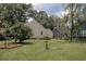 Lush backyard showcasing a well-maintained lawn, mature trees, and a charming bird bath at 1024 Palmetto St., Georgetown, SC 29440