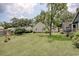 Expansive backyard featuring a lush lawn, mature trees, and neighboring houses at 1024 Palmetto St., Georgetown, SC 29440