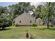 The home's serene backyard shows a well-maintained lawn and mature trees at 1024 Palmetto St., Georgetown, SC 29440