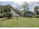 Green backyard featuring a well-maintained lawn, mature trees, and surrounding homes at 1024 Palmetto St., Georgetown, SC 29440