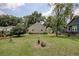 View of the home's backyard showing mature trees and established lawn at 1024 Palmetto St., Georgetown, SC 29440
