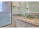 Updated bathroom showcasing vanity with granite countertop and tub with glass shower door at 1024 Palmetto St., Georgetown, SC 29440