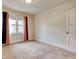 A bright bedroom with wallpaper, carpeted floor, and natural light filtering through the window at 1024 Palmetto St., Georgetown, SC 29440