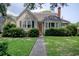 Charming single-story home with a classic design, including a brick chimney, a neat lawn, and tidy landscaping at 1024 Palmetto St., Georgetown, SC 29440