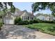 Charming single-story home with a well-manicured lawn and driveway, with mature trees adding shade at 1024 Palmetto St., Georgetown, SC 29440