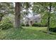 Charming home featuring a well-manicured front yard with mature landscaping and a cozy porch at 1024 Palmetto St., Georgetown, SC 29440