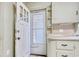Outdated kitchen features white cabinetry, screen door, and limited counter space at 1024 Palmetto St., Georgetown, SC 29440