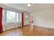 Open living room with hardwood floors, large windows and arched doorway at 1024 Palmetto St., Georgetown, SC 29440
