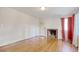 Living room features hardwood floors, a brick fireplace, and a large window with natural light at 1024 Palmetto St., Georgetown, SC 29440