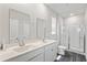 Bathroom features a double sink vanity, hard surface countertops, and a glass enclosed shower at 1074 Sennema Circle, Myrtle Beach, SC 29588