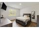 Bedroom with a large window, wood floors and a bed with decorative pillows at 1074 Sennema Circle, Myrtle Beach, SC 29588