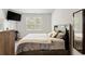 Bright bedroom with a large window, TV, stylish bedding, and dark wood furniture at 1074 Sennema Circle, Myrtle Beach, SC 29588
