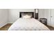 This bedroom showcases a bed with stylish grey pattern bedding and dark wood headboard at 1074 Sennema Circle, Myrtle Beach, SC 29588