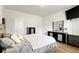 This bedroom is equipped with hardwood floors, a ceiling fan, and stylish dark wood furniture at 1074 Sennema Circle, Myrtle Beach, SC 29588