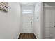 White front door, dark laminate flooring, and white walls at 1074 Sennema Circle, Myrtle Beach, SC 29588