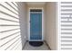 Close-up of a teal front door with detailed trim and modern hardware on a home with light-colored siding at 1074 Sennema Circle, Myrtle Beach, SC 29588