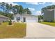A well-maintained single-Gathering home with a tidy lawn, concrete driveway, and an attached two-car garage at 1074 Sennema Circle, Myrtle Beach, SC 29588