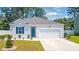 Charming single-story home featuring a teal front door, blue shutters, and a well-manicured lawn at 1074 Sennema Circle, Myrtle Beach, SC 29588